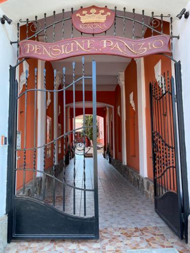an entrance to a building with a entrance gate at Pensiunea Korona in Miercurea-Ciuc