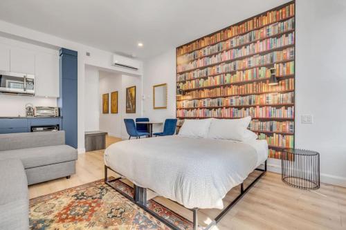 a bedroom with a bed and a large wall of books at Initial / Harry / Quebec+stat in Quebec City
