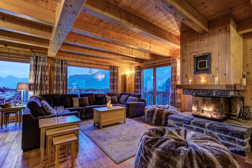 a living room with a couch and a fireplace at Chalet la Couronne in La Tzoumaz