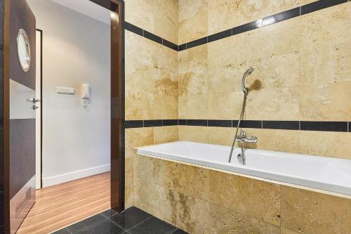 a bathroom with a tub and a shower at Apartamenty Świnoujście - Apartament morski Rezydencja Żeromskiego in Świnoujście