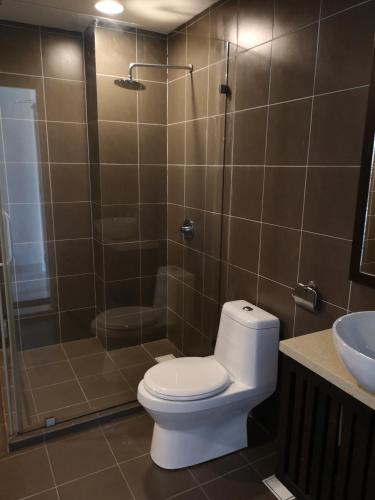 a bathroom with a toilet and a shower and a sink at Gold Coast Morib Rerost By Sweetime in Kampong Tanjong Pechah