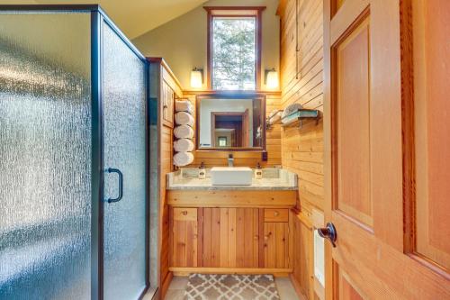 a bathroom with a sink and a mirror at Hungry Horse Cabin with Gas Grill, Near Glacier! in Hungry Horse
