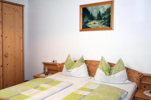 a bedroom with a bed and a picture on the wall at Apartments Haus Steinbock in Tauplitz