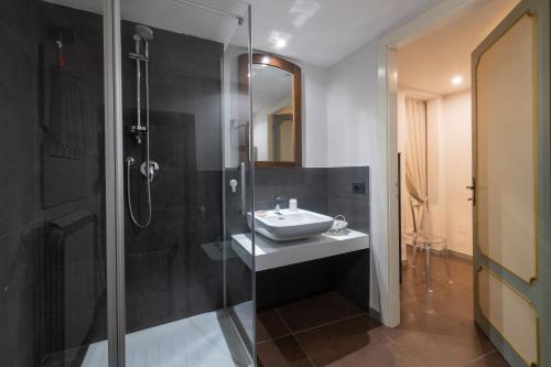 a bathroom with a sink and a shower at L'ira di Dante in Gubbio