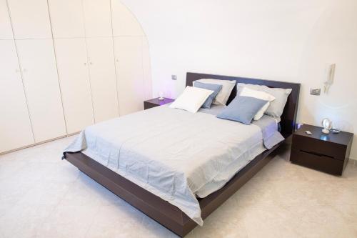 a bedroom with a large bed with two night stands at Dimora nel Palazzo Ducale in Giovinazzo