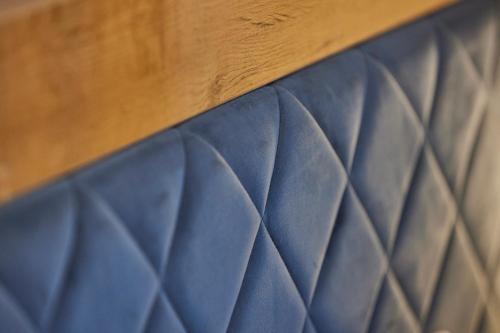a close up of the top of a blue bedsheet at Hotel Isha in Frankfurt/Main