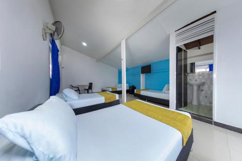 een slaapkamer met 2 bedden en een raam bij Hotel Confort Obelisk in Medellín
