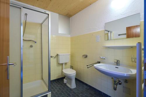 a bathroom with a sink and a toilet and a shower at Gasthof Lamm in Sankt Jodok am Brenner
