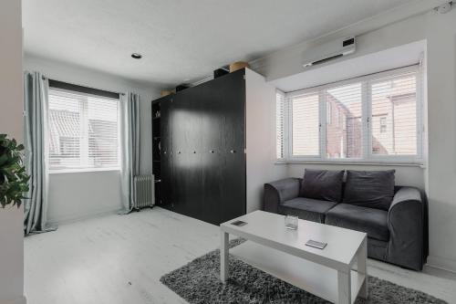a living room with a couch and a table at Hullidays - Trinity Studio Apt. in Hull