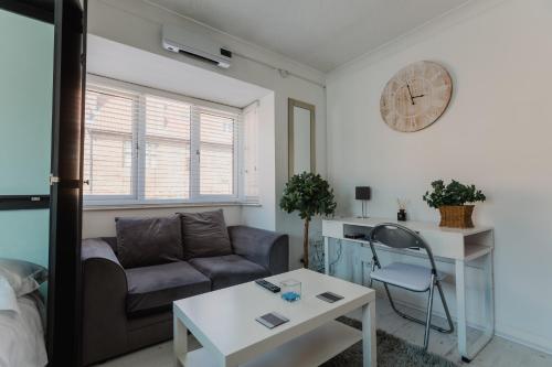 a living room with a couch and a table at Hullidays - Trinity Studio Apt. in Hull