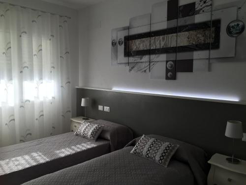 a bedroom with two beds and a window at Flyingaway in Borso del Grappa