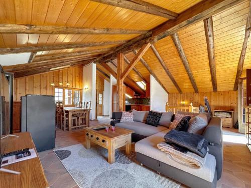a living room with a couch and a table at Chalet le Basset - Keys to Paradise in the Alps in La Fouly