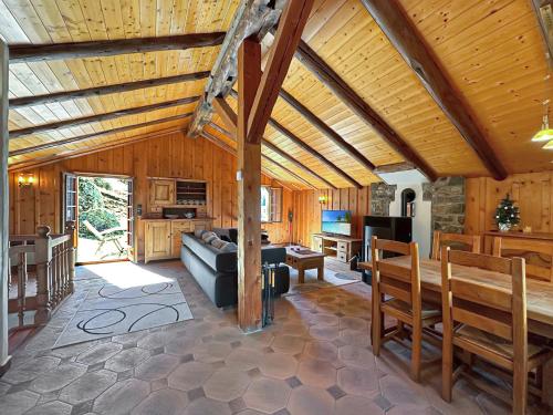 a large living room with a wooden ceiling at Chalet le Basset - Keys to Paradise in the Alps in La Fouly