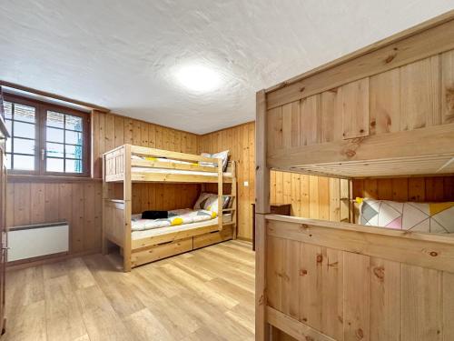 a room with two bunk beds in it at Chalet le Basset - Keys to Paradise in the Alps in La Fouly