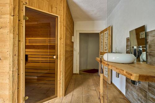 a bathroom with a sink and a sauna at Gasthof Lamm in Sankt Jodok am Brenner