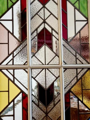 a stained glass window with a person looking through it at Beautiful large stylish villa centrally located in Pons in Pons