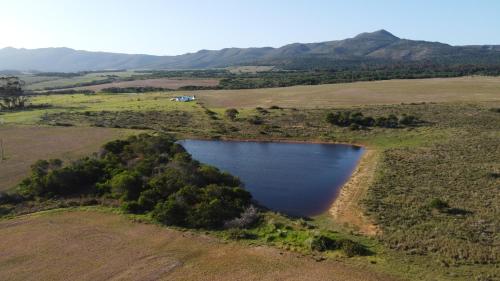 an aerial view of a lake in a field at Ou Werf Farm Cottage in Bredasdorp