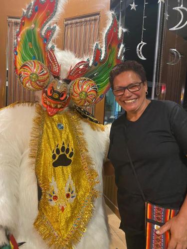 a man is standing next to a costume on aumed animal at La Negrita Host in Sucre