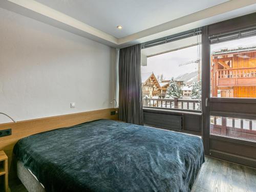 a bedroom with a bed and a large window at Appartement Val-d'Isère, 2 pièces, 4 personnes - FR-1-694-262 in Val-d'Isère