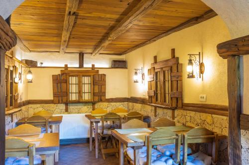 a restaurant with tables and chairs in a room at Golden Lakes Rooms in Plitvička Jezera