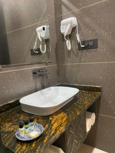 a bathroom with a white sink on a counter at Hotel Azul Ganga in Rishīkesh