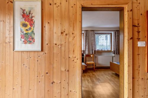 a room with wooden walls and a picture on the wall at Stöcklhuberhof in Vandoies