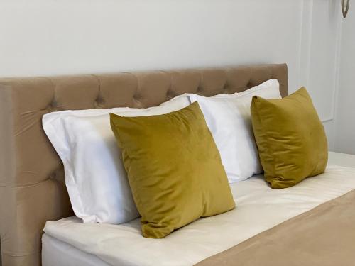 a group of four pillows sitting on a bed at Pensiunea Korona in Miercurea-Ciuc