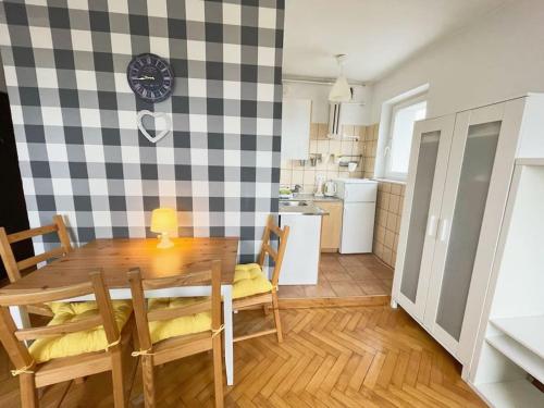 a kitchen and dining room with a table and chairs at Cozy studio apartment Yellow in Gdansk Wrzeszcz in Gdańsk