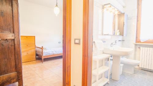 a white bathroom with a sink and a toilet at In the Heart of Reinessance - Italian Homing in Solferino