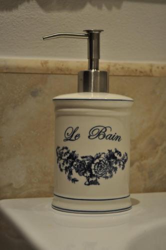 a soap dispenser sitting on top of a sink at Buonincontro Apartment in Florence