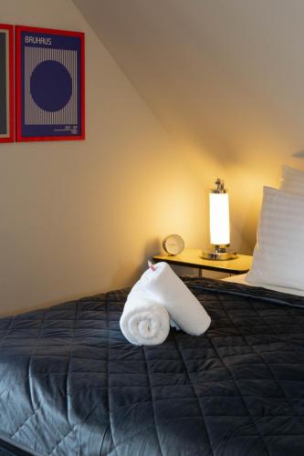 a hotel room with a bed with a towel on it at Apartmány Kopacka in Svitavy