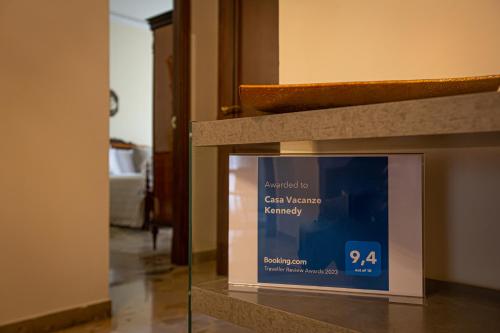 a display case with a sign in a room at Casa Vacanze Kennedy in Favara