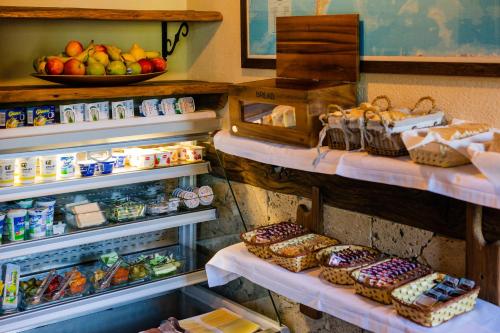 a refrigerator filled with lots of different types of food at Golden Lakes Rooms in Plitvička Jezera