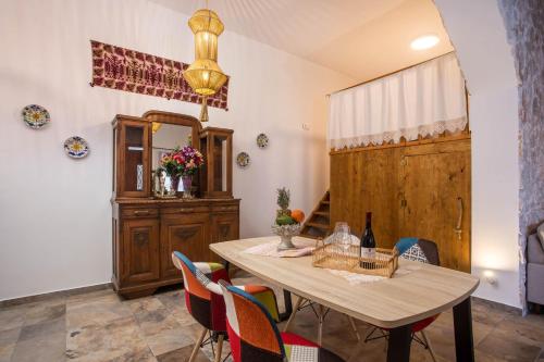 a dining room with a table and chairs at Traditional Loft Casa Di Vini in Kalithies