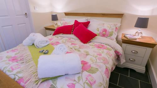 a bed with two towels and two dolls on it at Hen Bost Nefyn in Nefyn