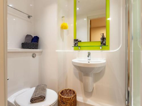 a bathroom with a sink and a toilet and a mirror at For Students Only City Living Modern Studios at Hannah Court in Sheffield in Sheffield