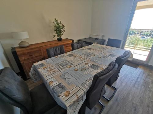 une table dans une pièce avec des chaises et une table avec dans l'établissement 5008 Circé 515, au Cap d'Agde
