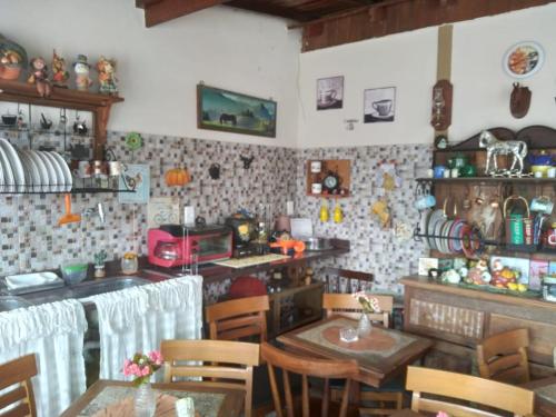 a kitchen with tables and chairs in a room at Pousada Café Country in Petrópolis