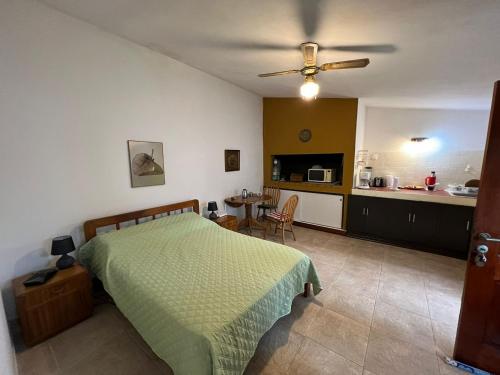 a bedroom with a bed and a kitchen at Linda casa en Barra de Carrasco in Montevideo