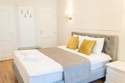 a bedroom with a large bed with yellow pillows at Pensiunea Korona in Miercurea-Ciuc