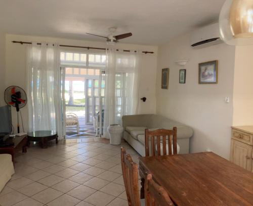 a living room with a couch and a table at Belle Mare 3 bedroom Luxury villa 6 on a blue ocean in Palmar