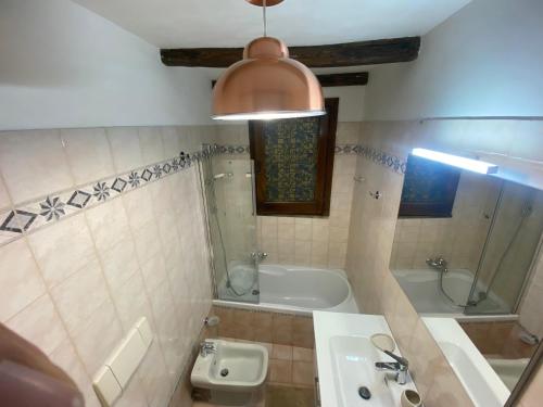 a bathroom with a sink and a tub and a toilet at Appartamento Vista Lago in Anguillara Sabazia
