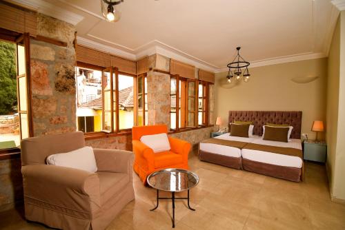 a bedroom with a bed and a couch and a table at Gorgeous Flat near Hadrian's Gate in Antalya