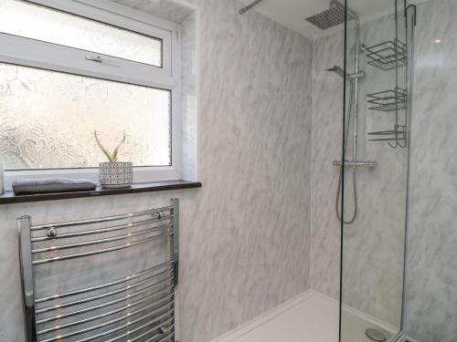 a bathroom with a shower and a window at Tinners in Gunnislake