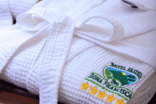 a white blanket with a label on it at Hotel Fazenda Dona Francisca in Joinville