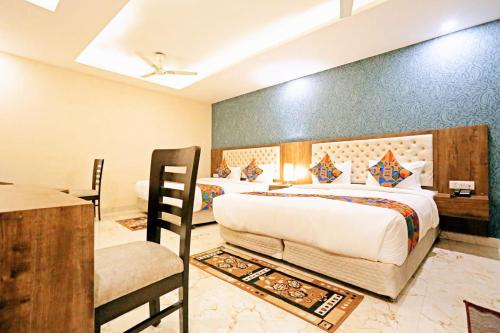 a bedroom with a bed and a desk and a chair at Mayda Inn- A Boutique Hotel in New Delhi