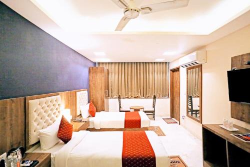 a hotel room with two beds and a television at Mayda Inn- A Boutique Hotel in New Delhi