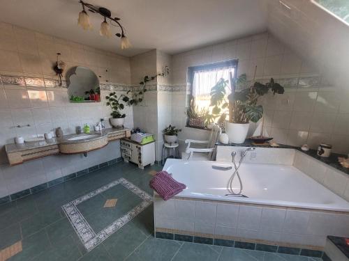 a large bathroom with a tub and a sink at Ferienwohnung Schmidt in Neu Sallenthin