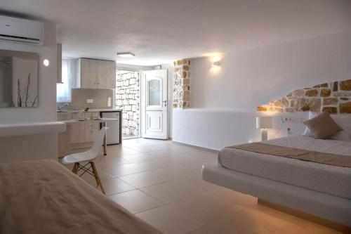 a bedroom with a bed and a kitchen with a counter at Irini's house with Jacuzzi in Dhragoulás