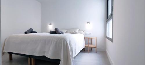 a white bedroom with a white bed in a room at Panorama Beach - Sea Breeze Apartment in Torrox Costa